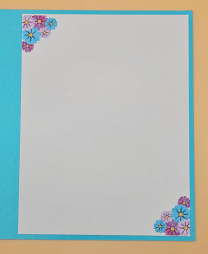 Floral corner design on a plain sheet with blue border