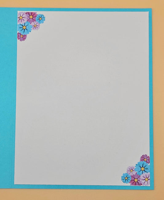 Floral corner design on a plain sheet with blue border