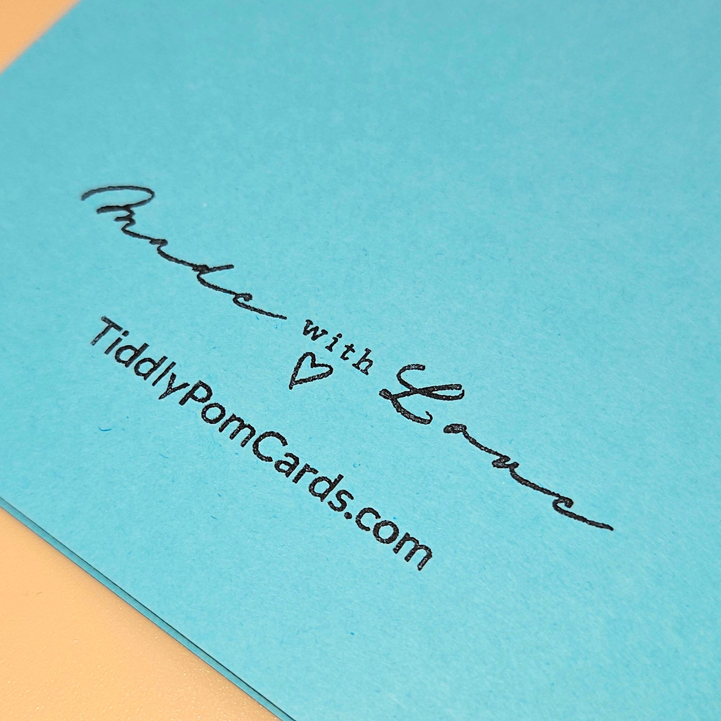 Blue card with 'Made with Love' text and website URL on a light blue background
