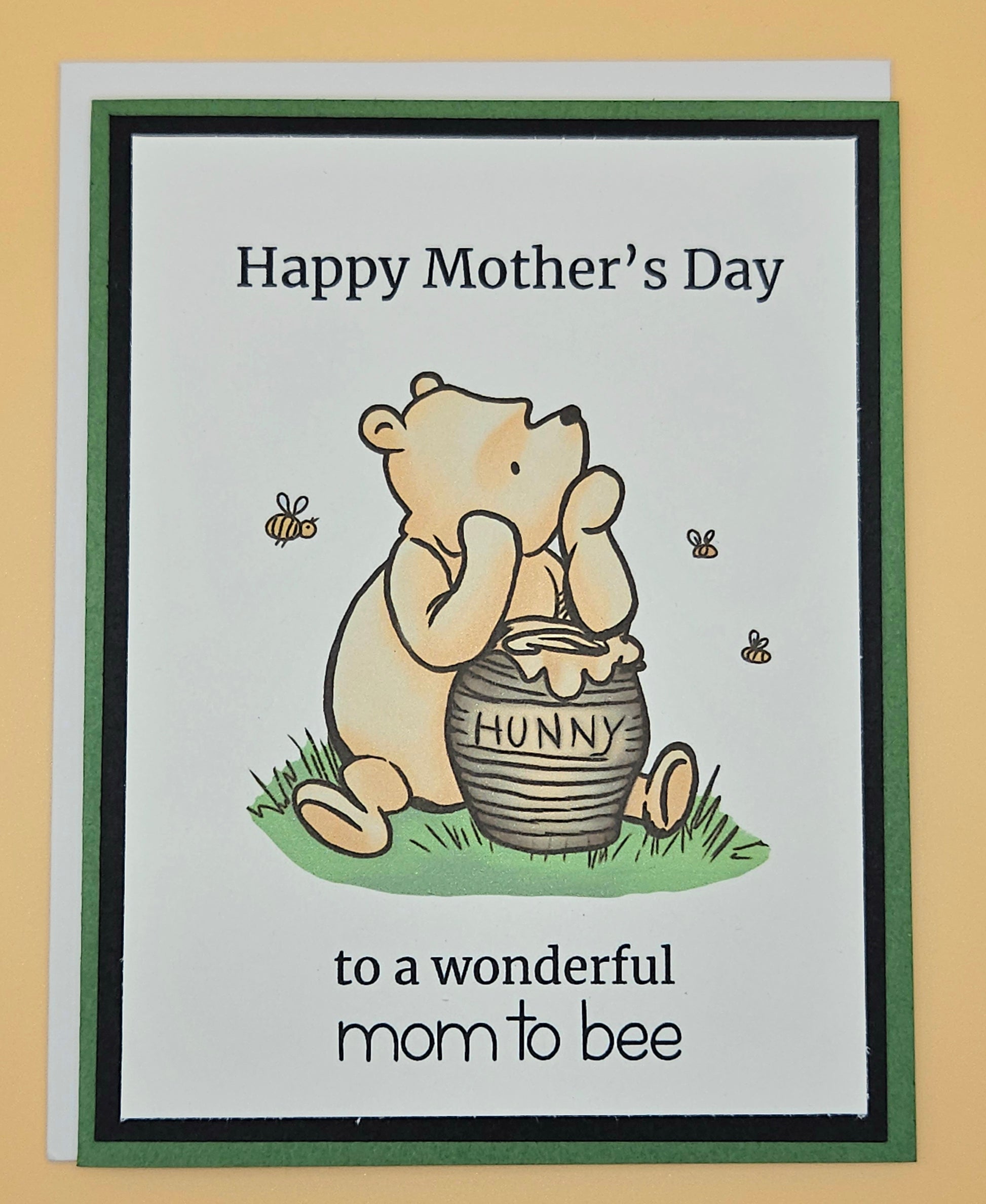 Mother's Day card with a bear holding a honey pot and text on a beige background