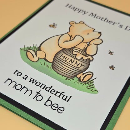 Mother's Day card with Winnie the Pooh holding a honey pot and text.