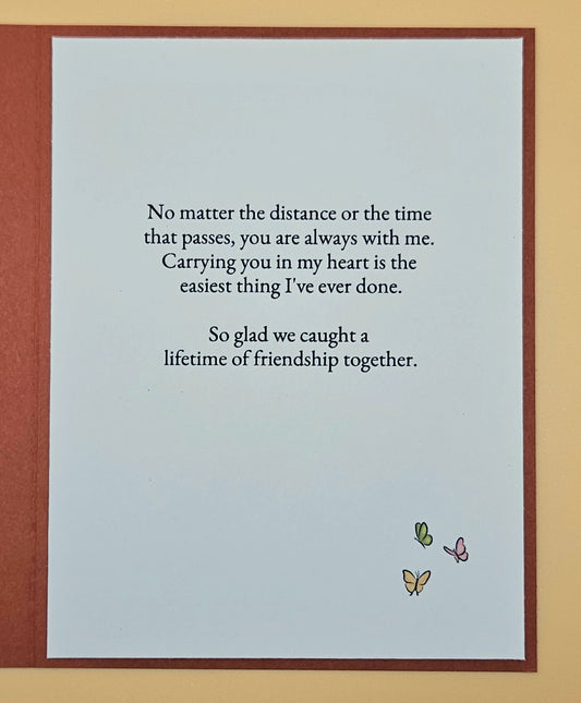 Card with a heartfelt message about friendship and butterflies on a light blue background.