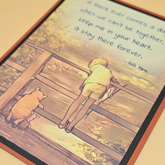 Illustration of a child and bear on train tracks with a quote by A.A. Milne.