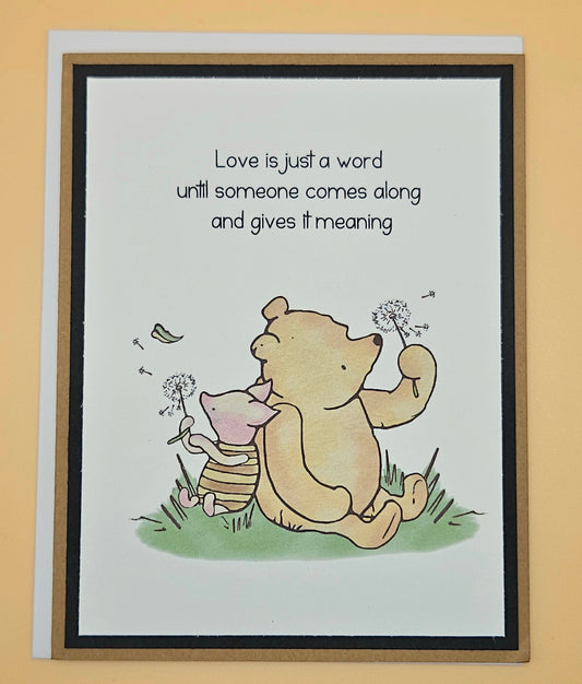 Card with Winnie the Pooh and Piglet holding dandelions and a quote about love.