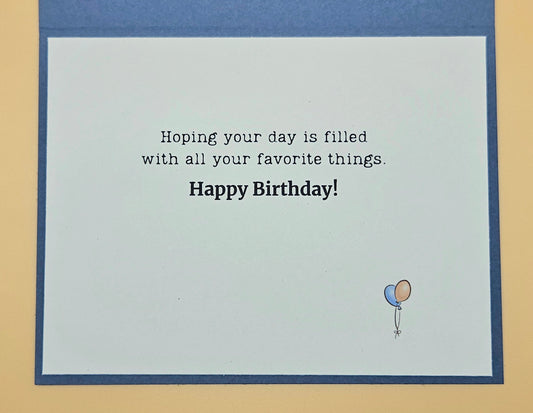 Birthday card with text and balloon illustration on a blue border