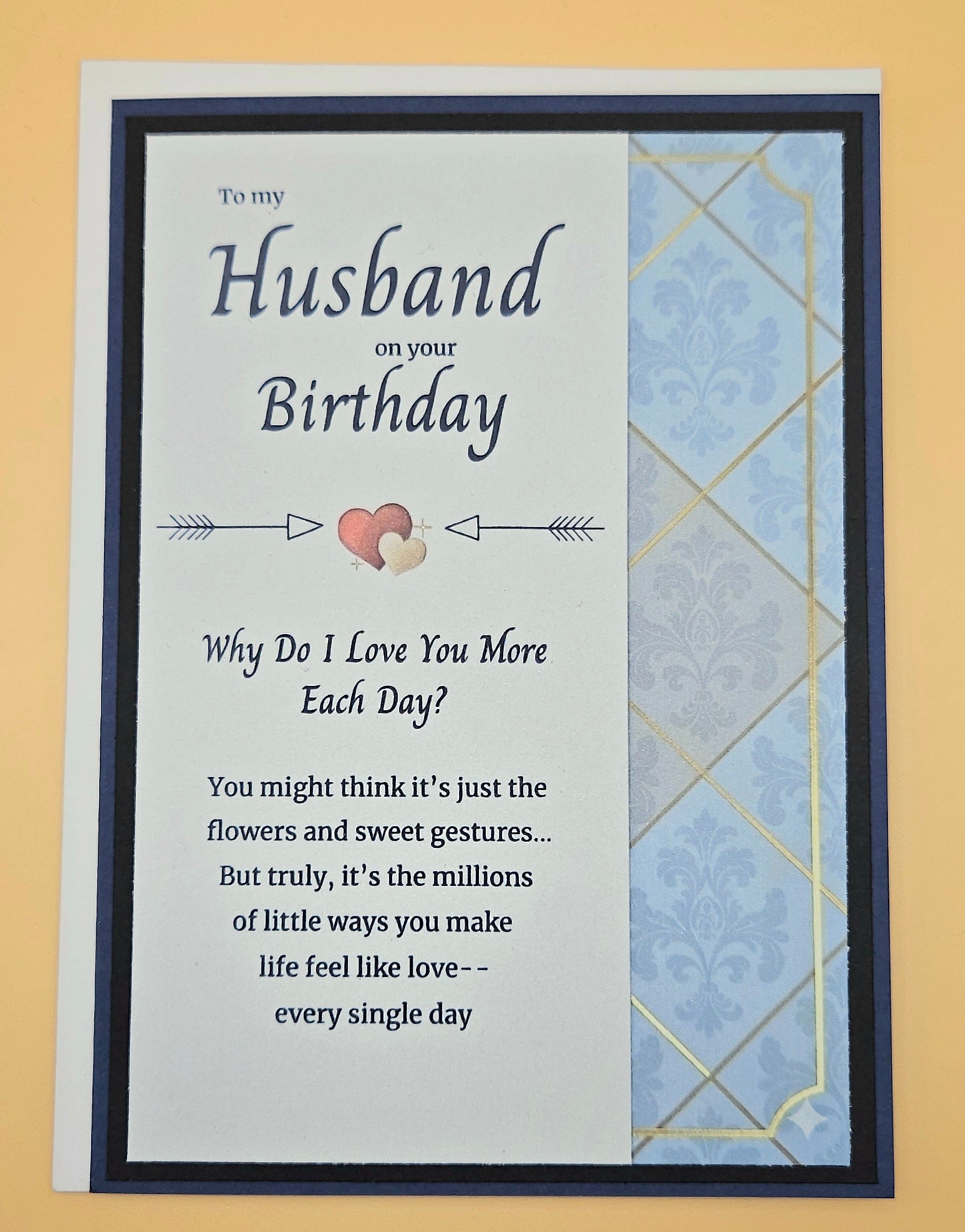 Birthday card for a husband with a heart and arrow design on a blue and gold patterned envelope.