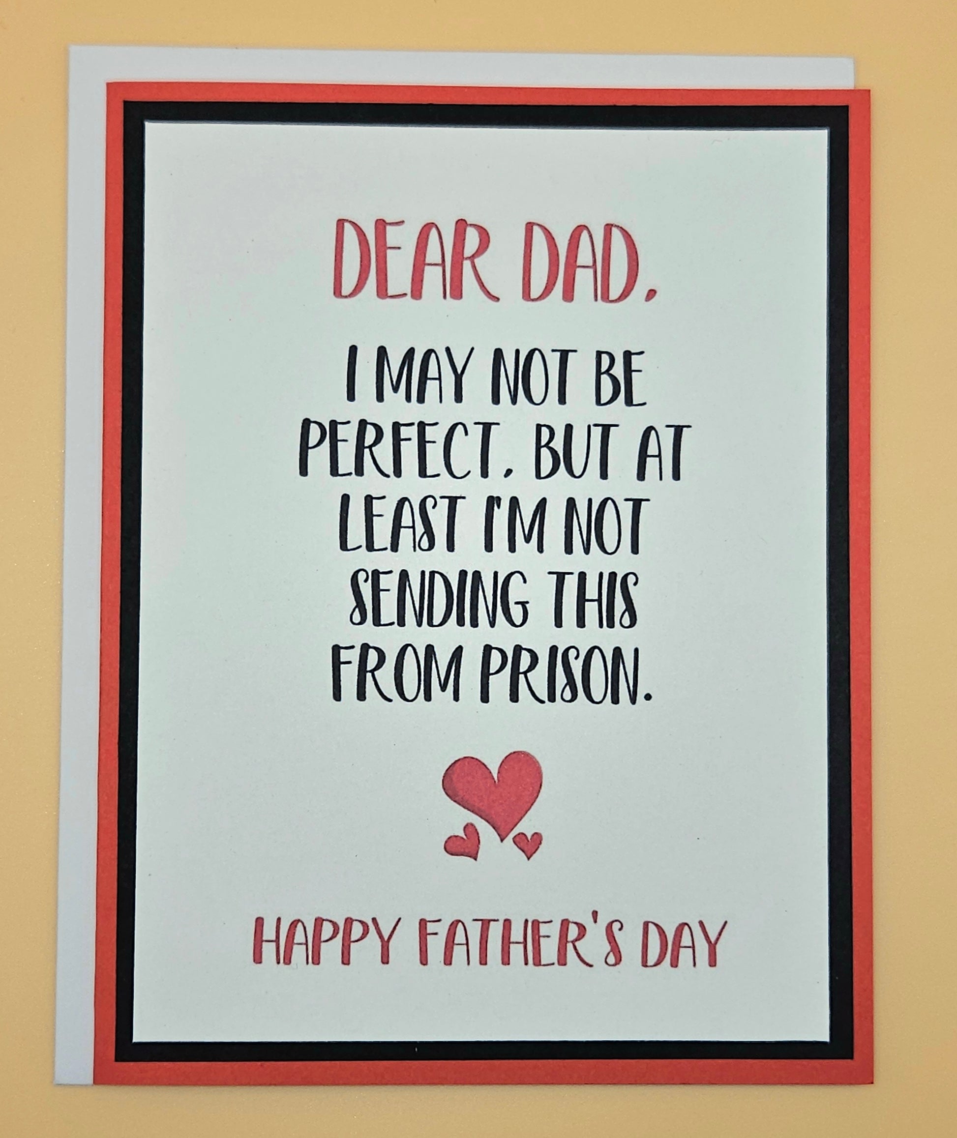 Father's Day card with humorous message and red hearts on a beige background