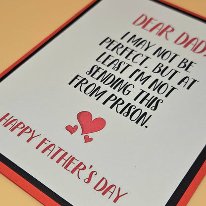 Father's Day card with humorous message and hearts on a plain background