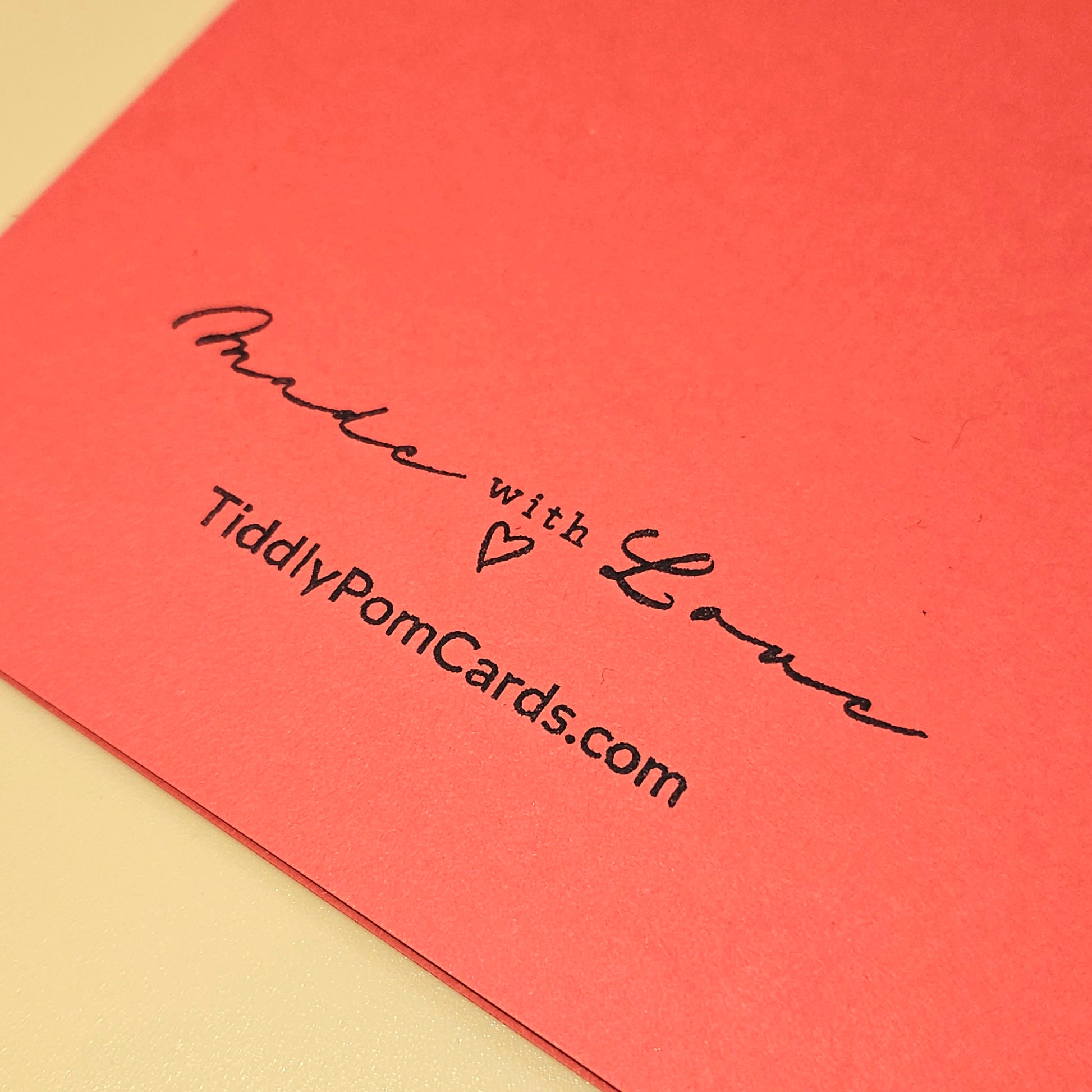 Red card with 'Made with Love' text and TiddlyPomCards.com on a beige background