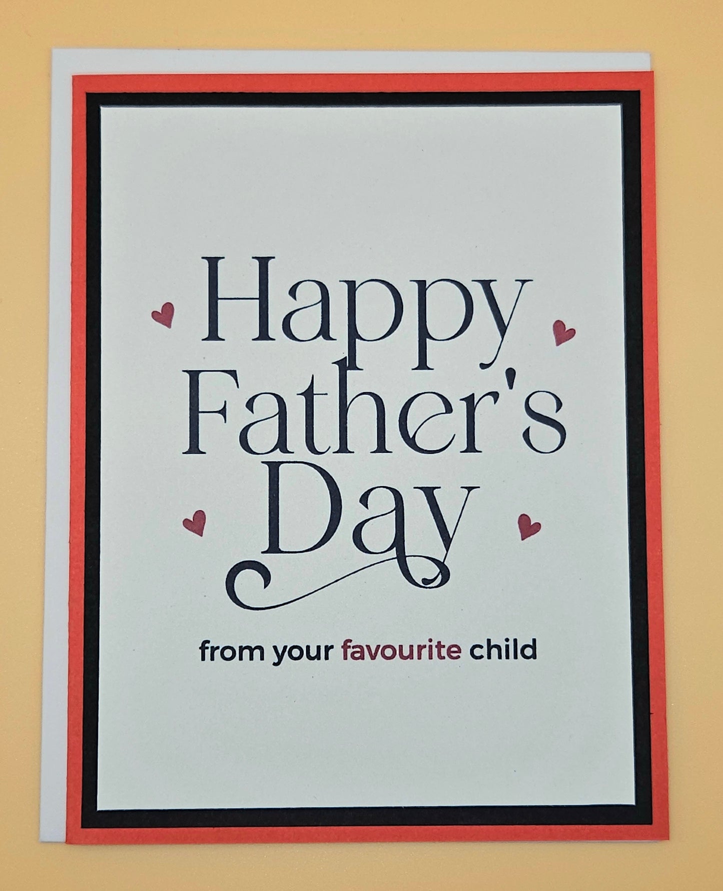 Father's Day card with text 'Happy Father's Day from your favourite child' on a beige background
