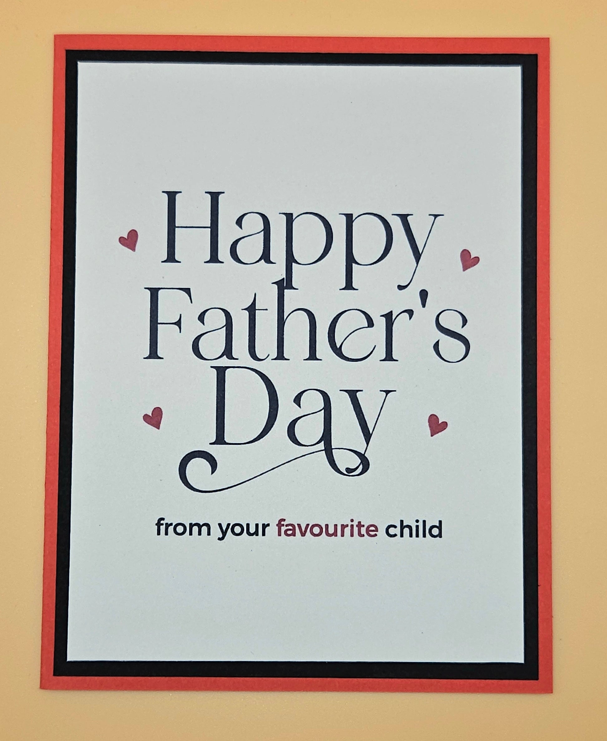Framed card with 'Happy Father's Day from your favourite child' text on a beige background