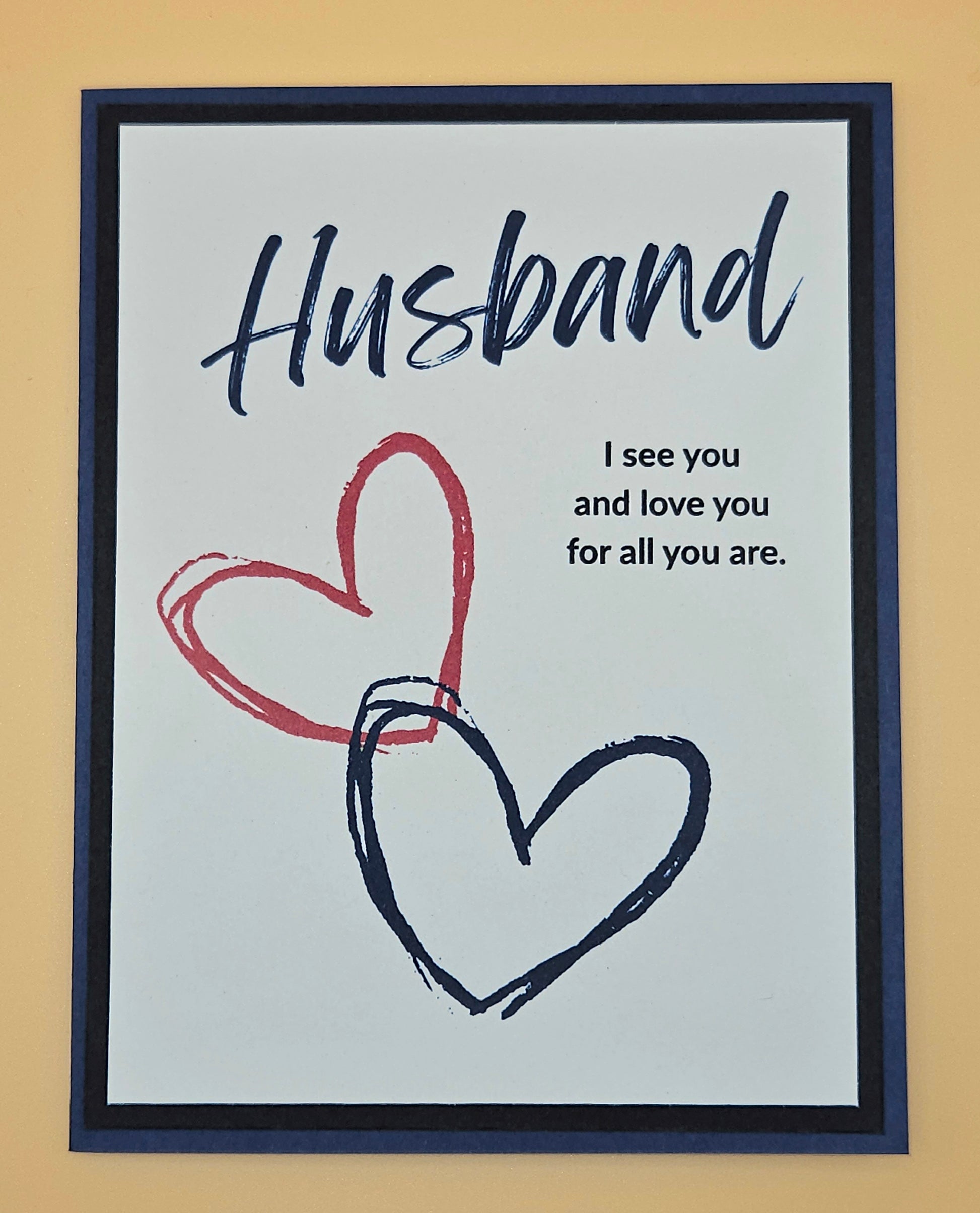 Framed artwork with 'Husband' text and hearts on a beige background