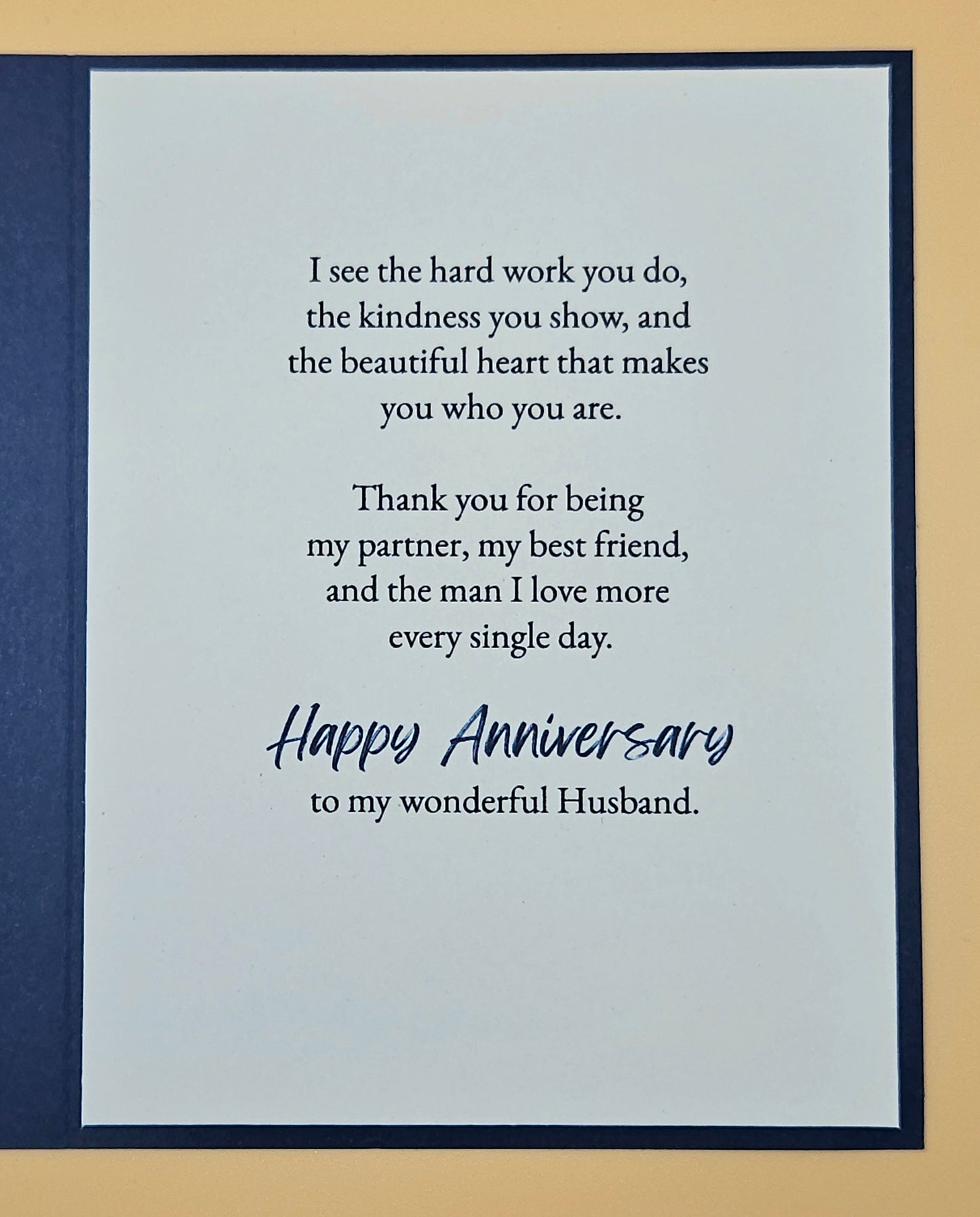 Card with anniversary message for a husband on a blue and beige background