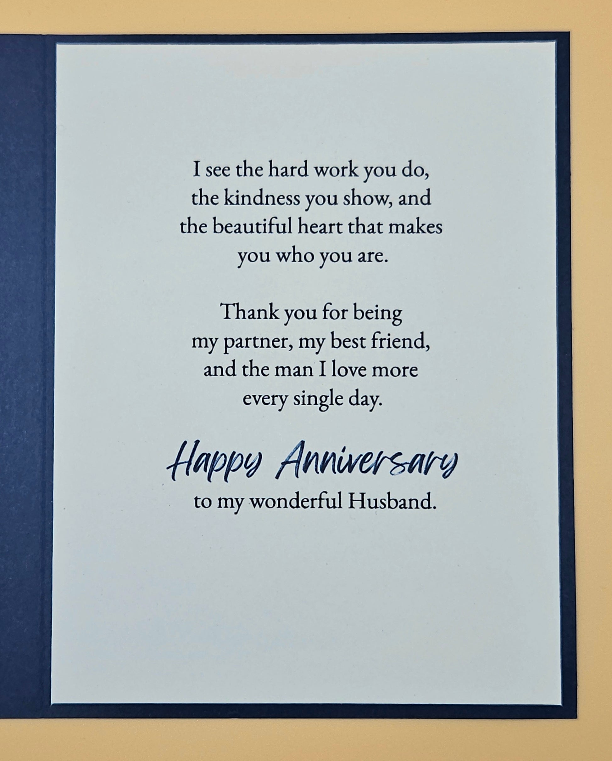 Card with anniversary message for a husband on a blue and beige background