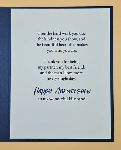 Card with anniversary message for a husband on a blue and beige background