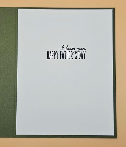Framed card with 'I love you Happy Father's Day' text on a beige background
