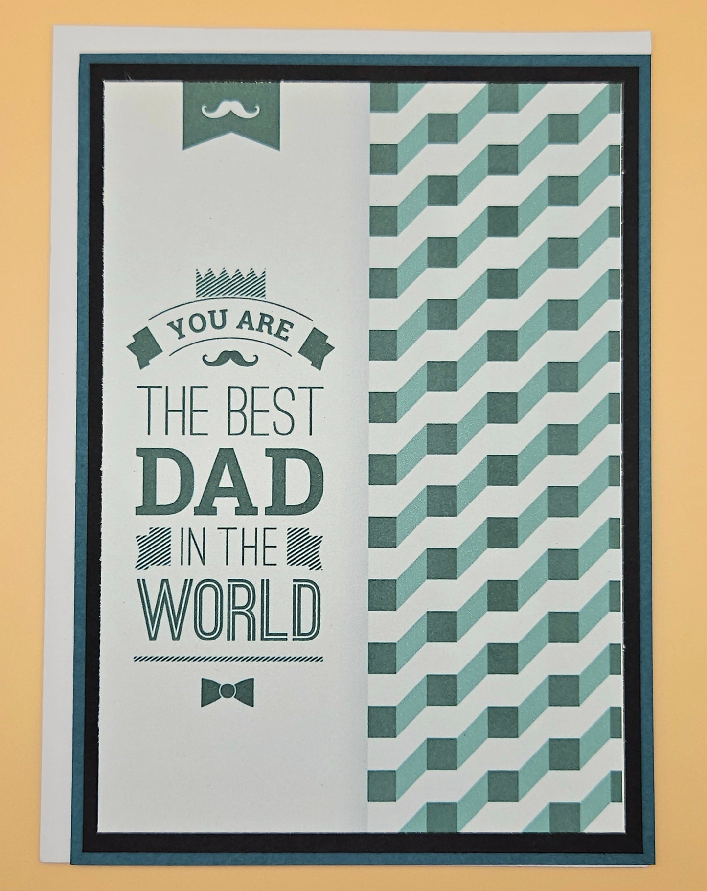 Greeting card with text 'You are the best dad in the world' and geometric pattern on a beige background