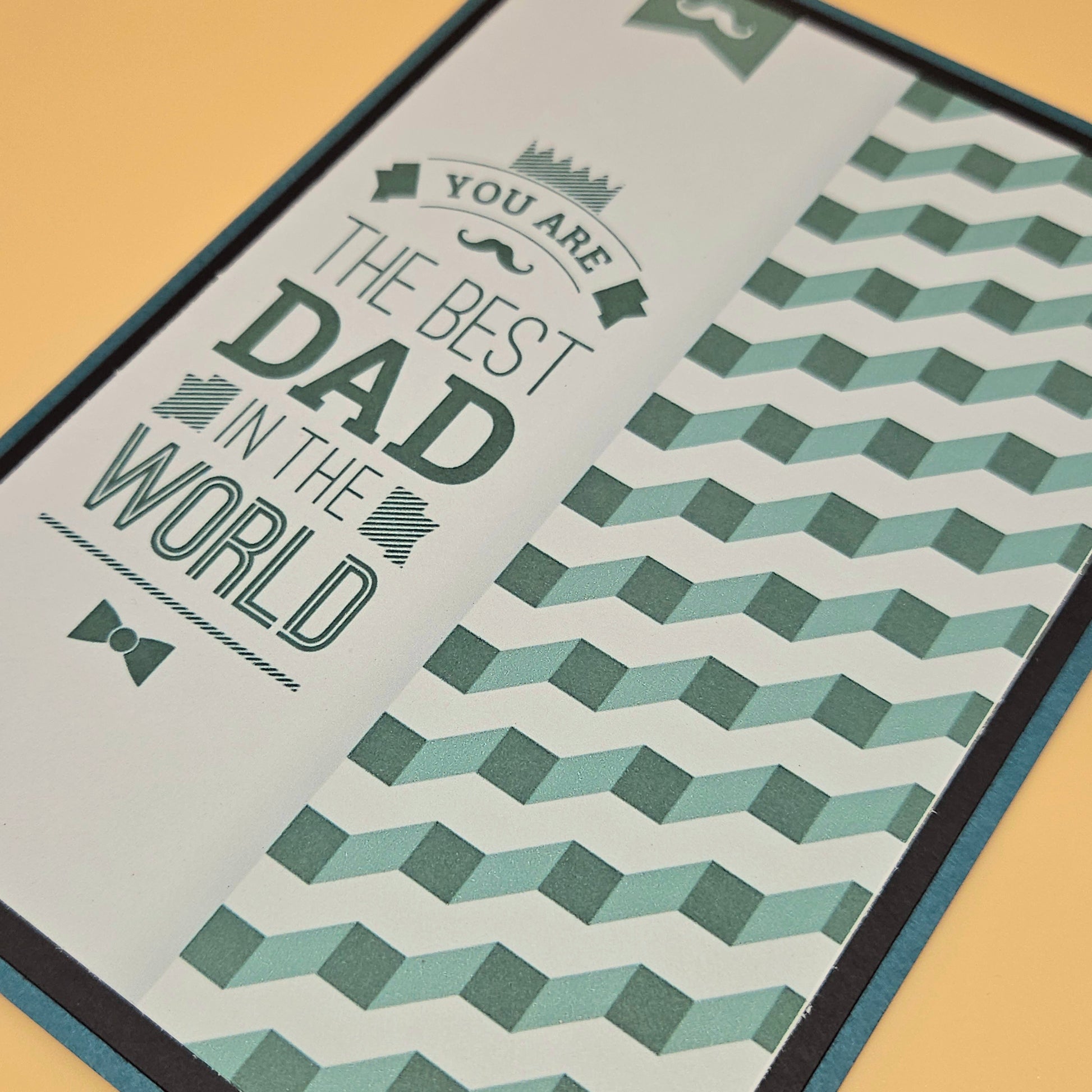 Greeting card with text 'You are the best dad in the world' on a geometric patterned background