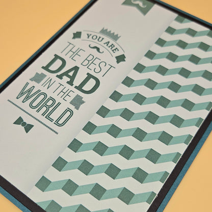 Greeting card with text 'You are the best dad in the world' on a geometric patterned background