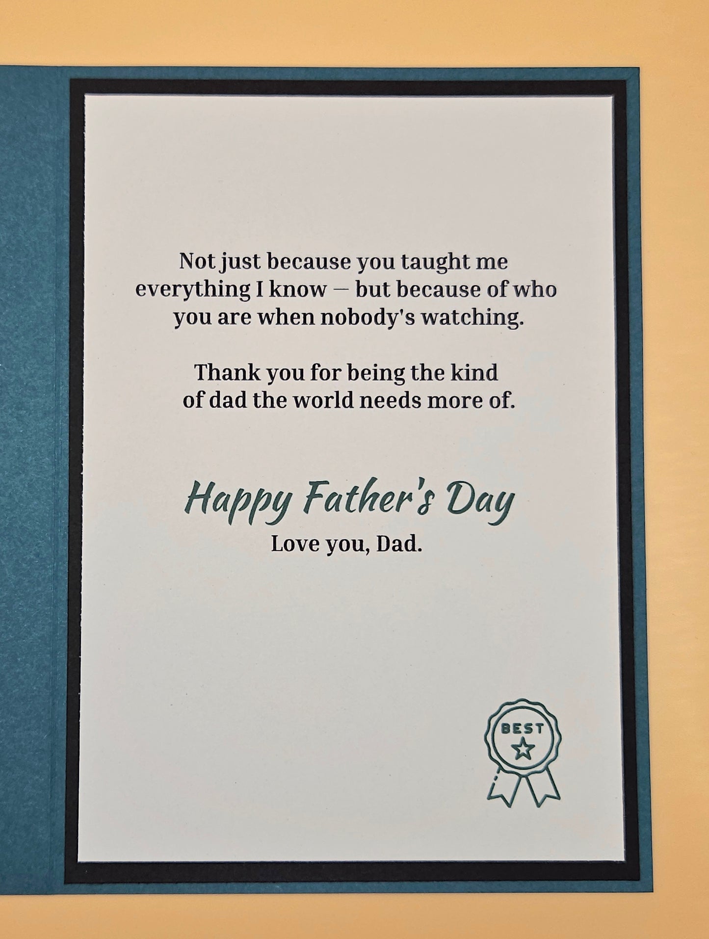 Framed Father's Day card with a message and 'Best Dad' ribbon on a beige background
