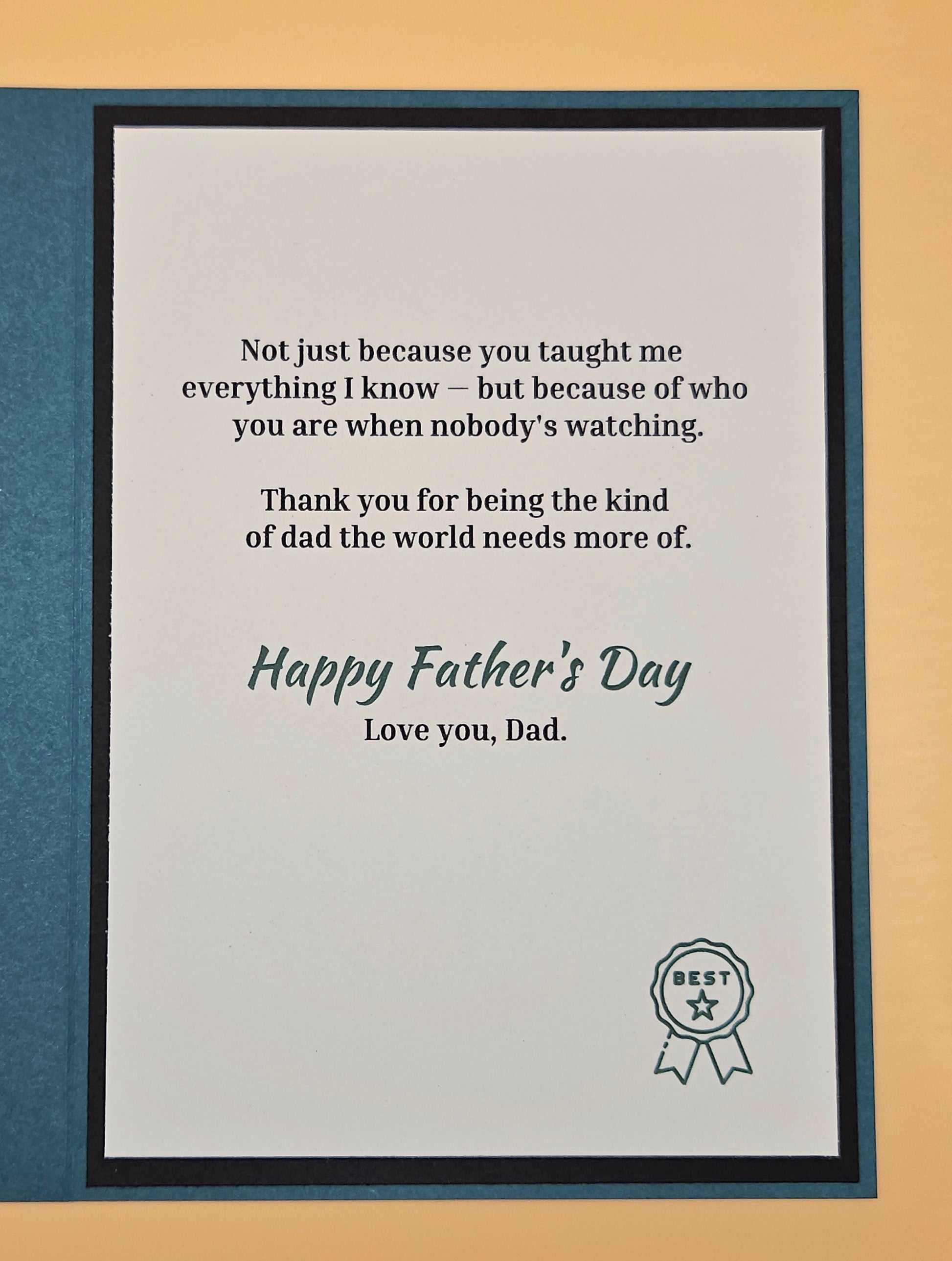 Framed Father's Day card with a message and 'Best Dad' ribbon on a beige background