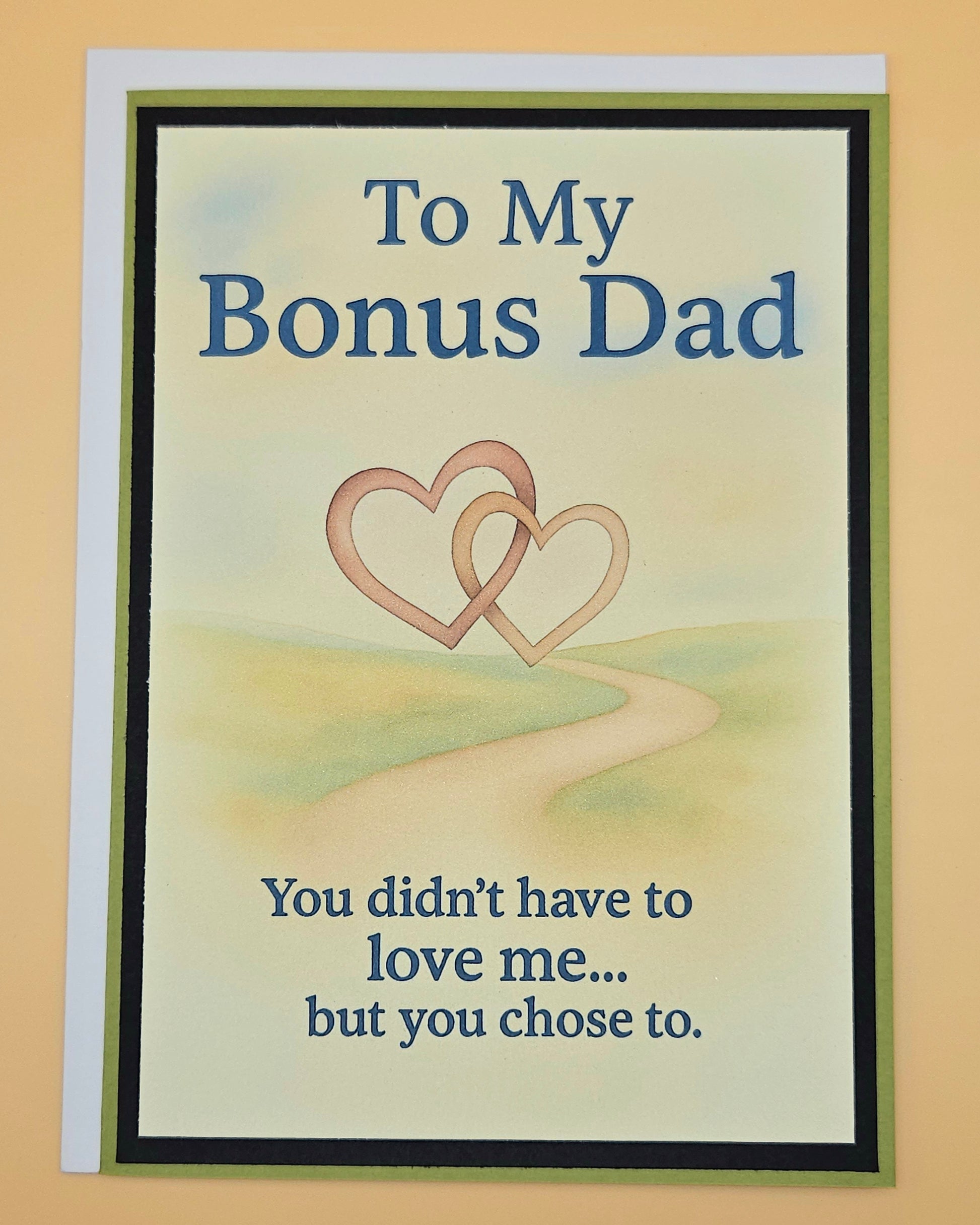 Greeting card for a bonus dad with two interlocking hearts and text on a beige background