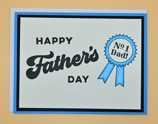 Father's Day card with 'Happy Father's Day' text and a blue ribbon badge on a beige background