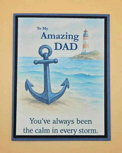 Card with anchor and lighthouse illustration, text 'To My Amazing DAD You've always been the calm in every storm.' on a beige background.