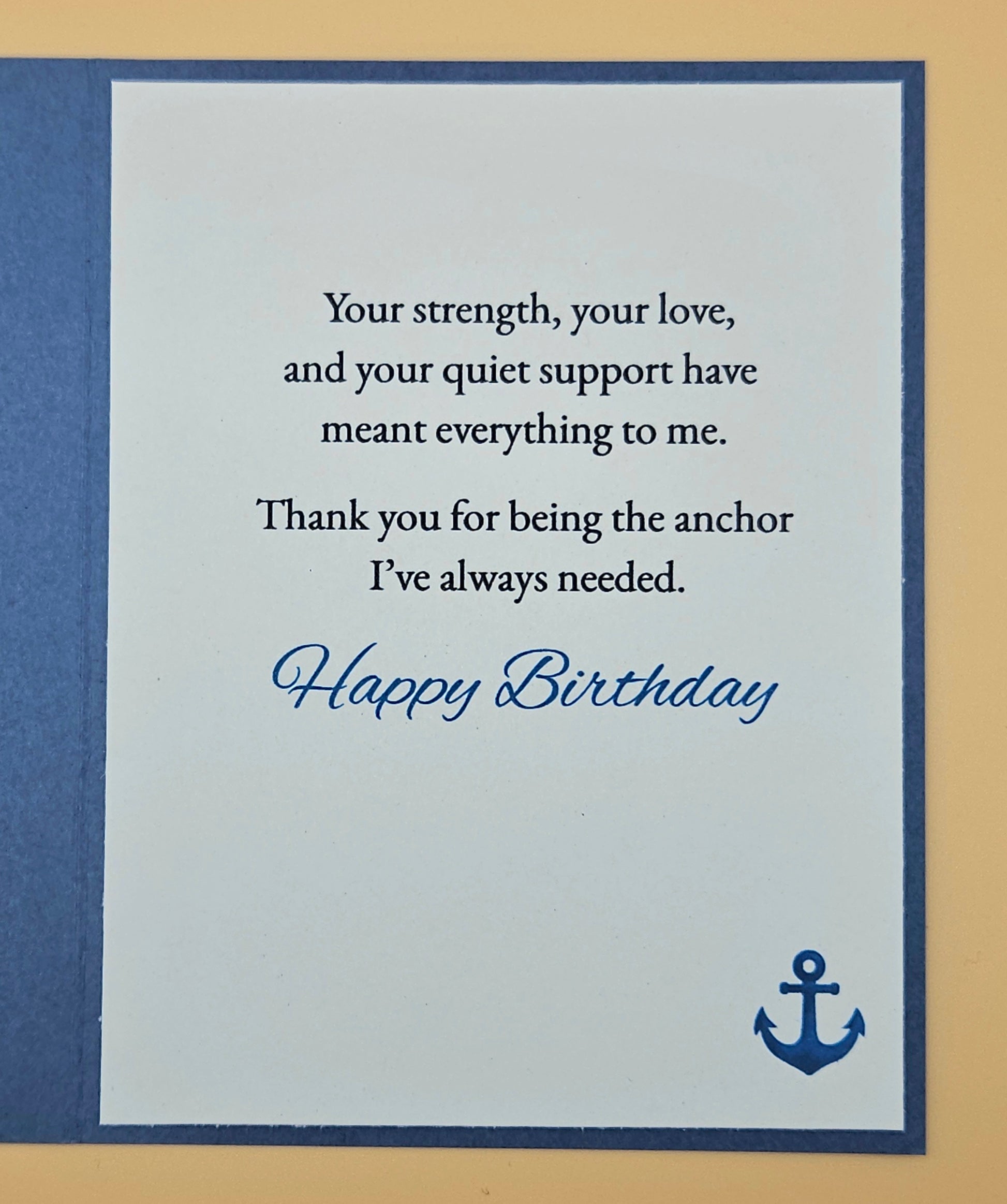 Birthday card with a message of appreciation and an anchor symbol on a blue and beige background.