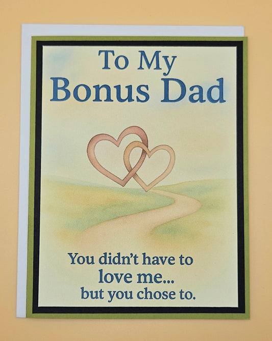 Card for a bonus dad with two interlocking hearts and text on a beige background