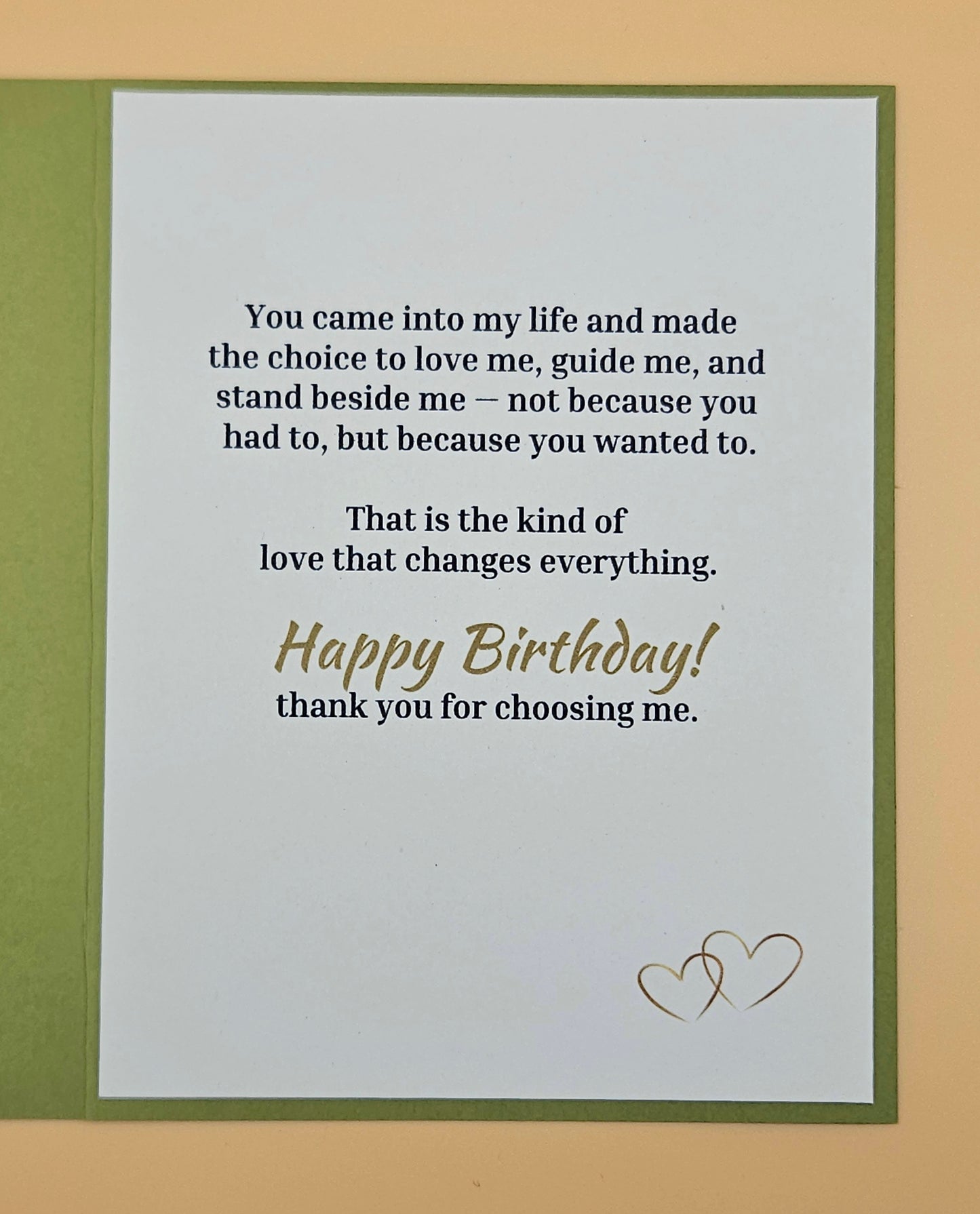 Birthday card with romantic message and two hearts on a beige background