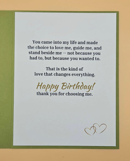 Birthday card with romantic message and two hearts on a beige background
