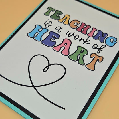 Colorful poster with 'Teaching is a work of heart' text on a light background
