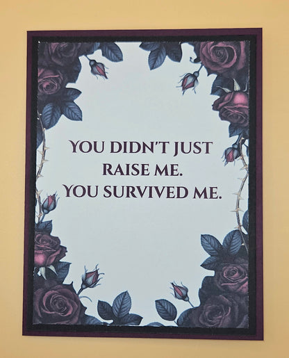 Framed poster with roses and text 'YOU DIDN'T JUST RAISE ME. YOU SURVIVED ME.' on a beige background