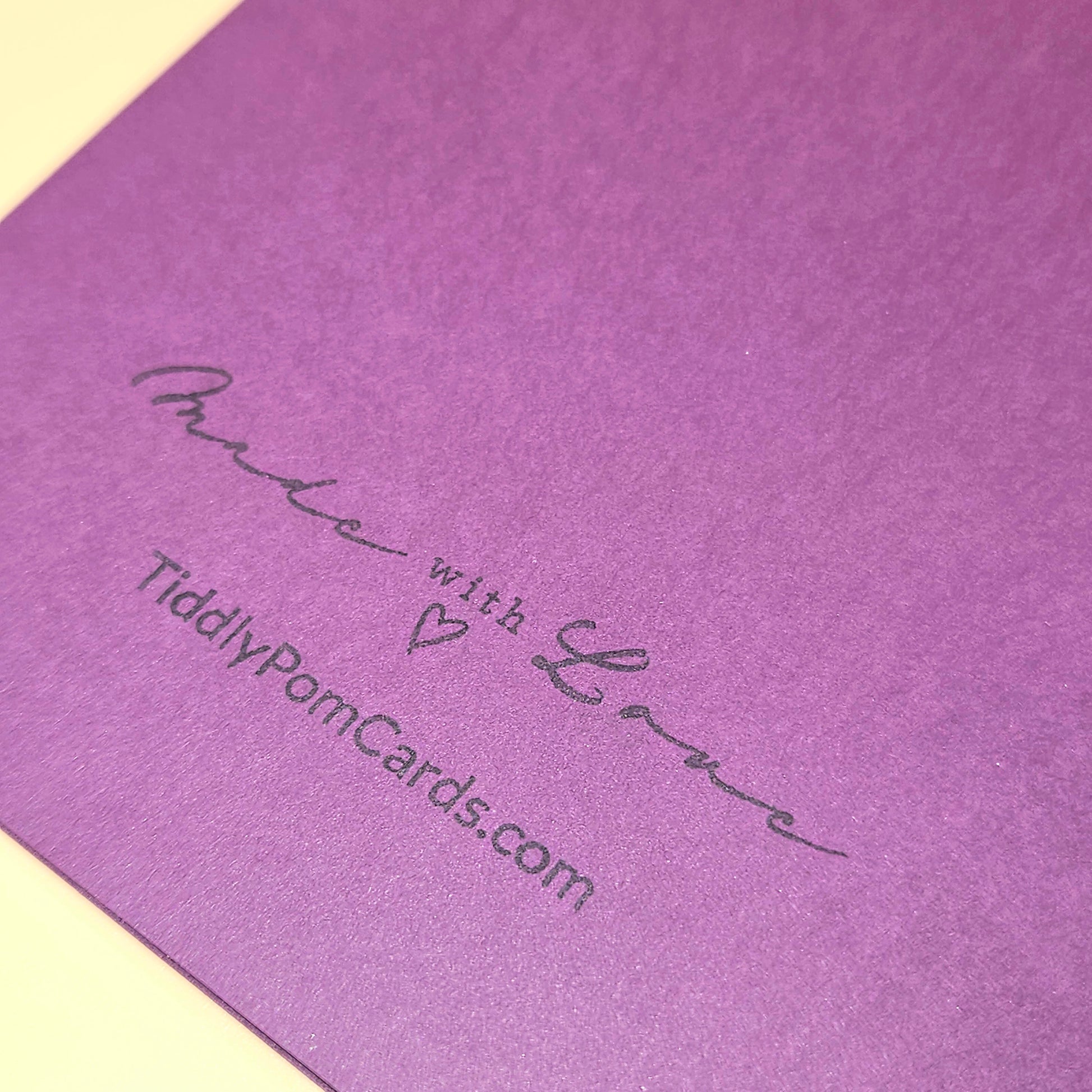 Purple card with 'Made with Love' text and website URL on a matching purple background