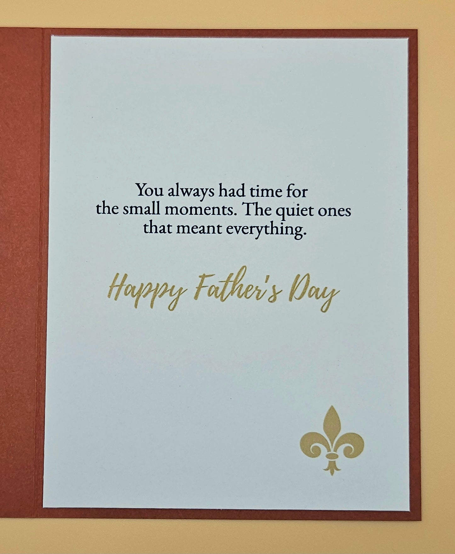 Father's Day card with text and fleur-de-lis design on a beige background