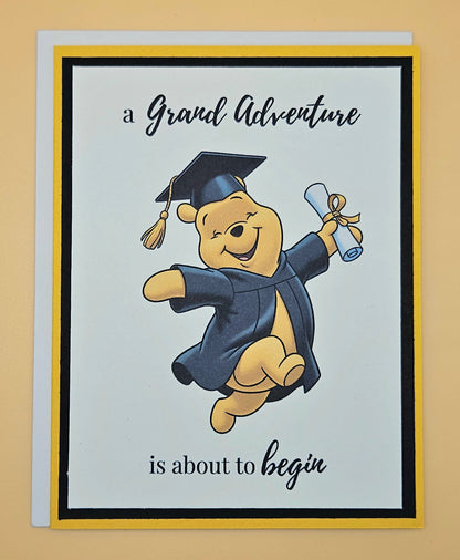 Graduation-themed card with a cartoon bear in a cap and gown on a beige background
