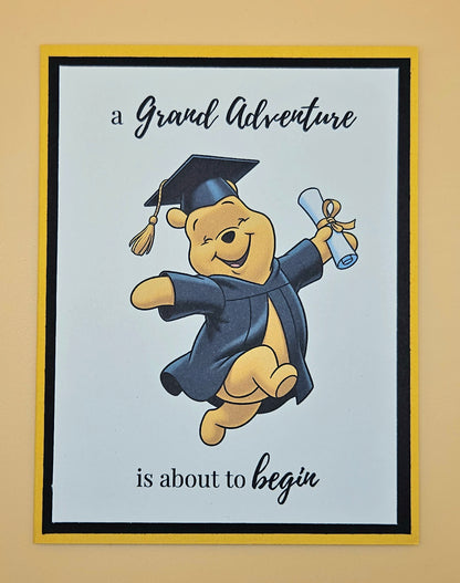 Cartoon bear in graduation attire with text 'A Grand Adventure is about to begin' on a light blue background.