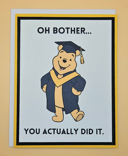 Graduation-themed card with cartoon bear in cap and gown on a beige background