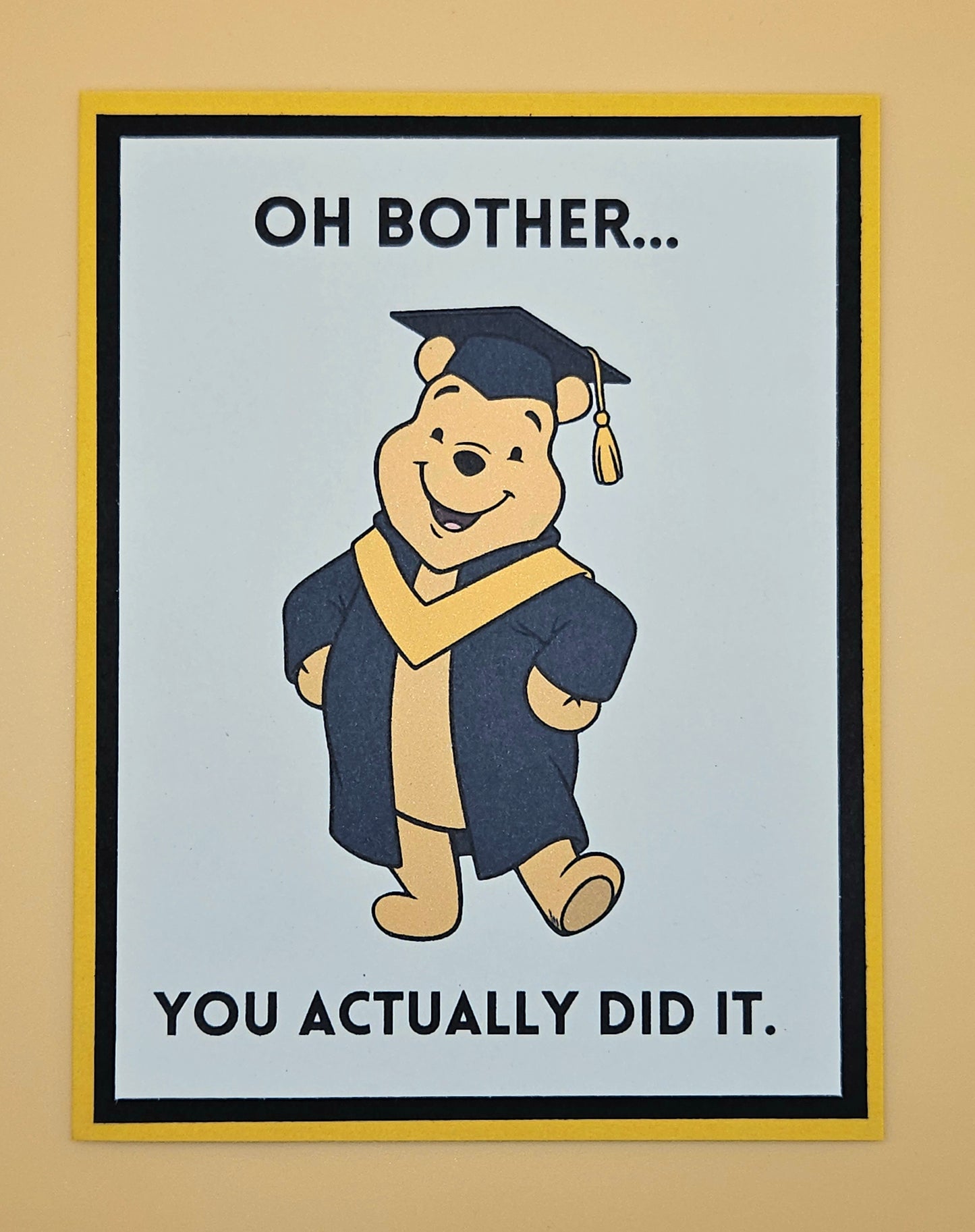 Cartoon bear in graduation attire with text on a beige background
