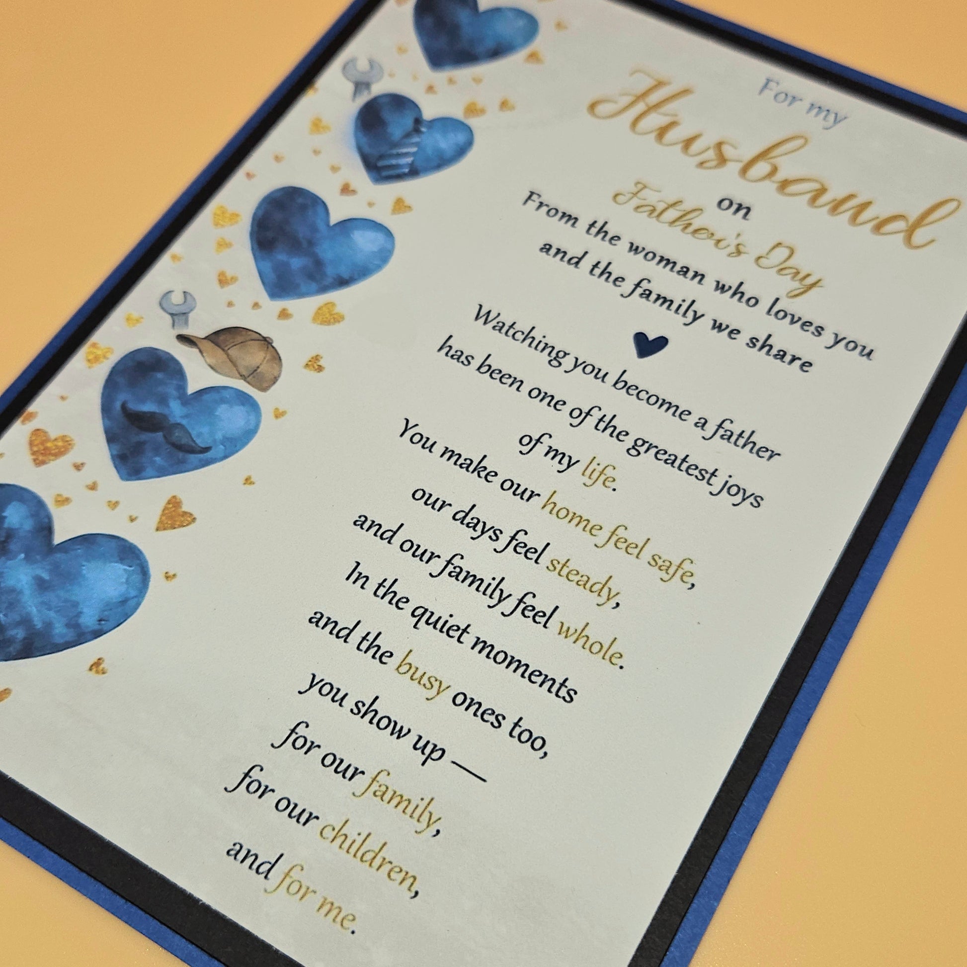 Father's Day card for husband close up showing blue heart column with dad icons and gold mini hearts
