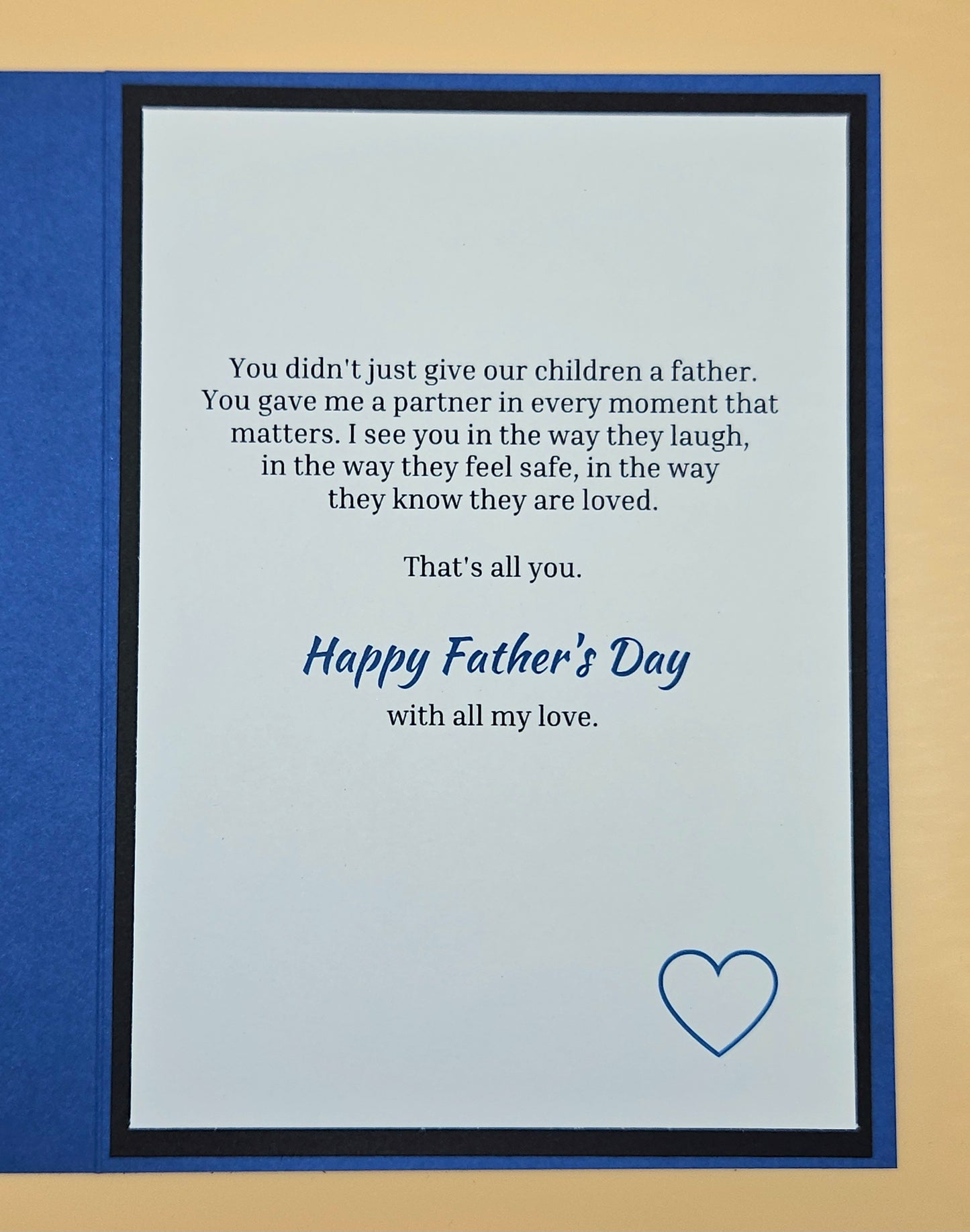 Inside of Father's Day husband card showing printed heartfelt sentiment and blue compass accent