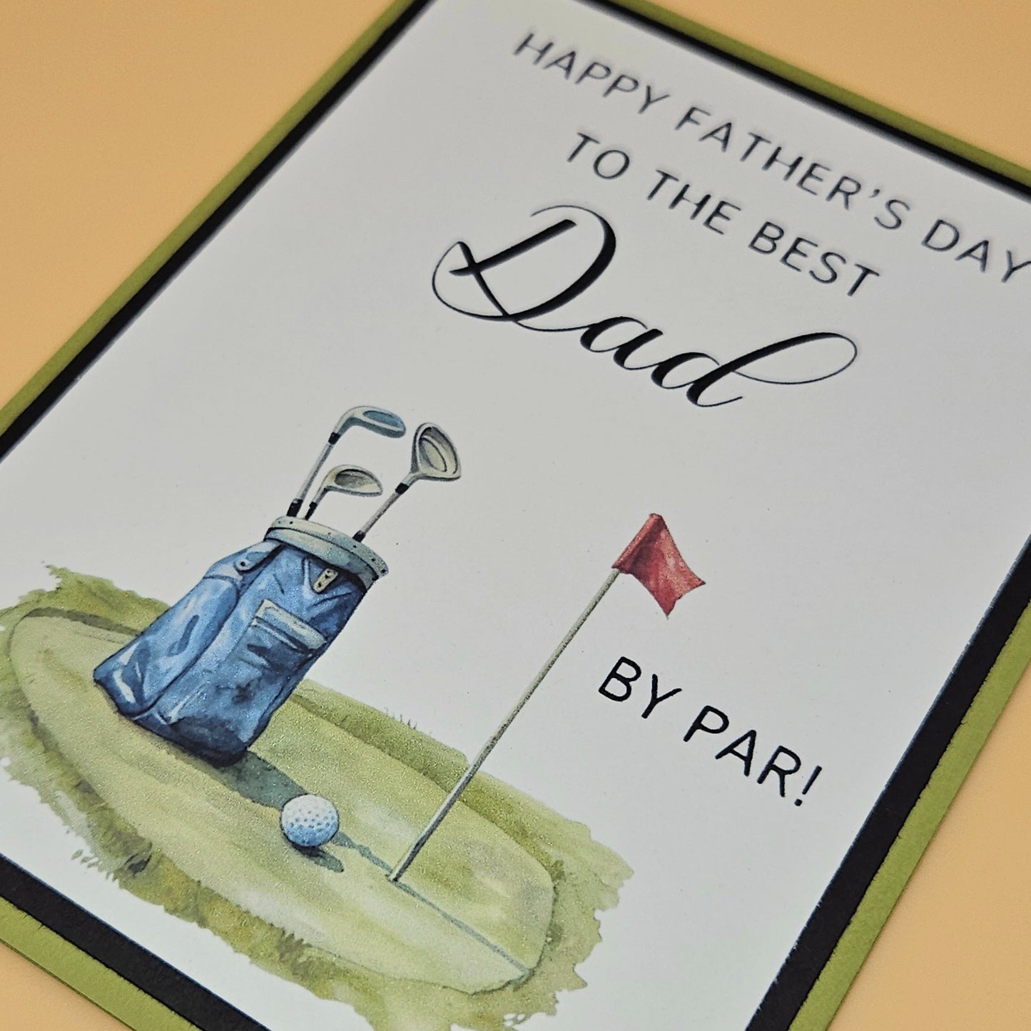 Close up of Father's Day golf card front showing Best Dad By Par sentiment and watercolor golf scene detail