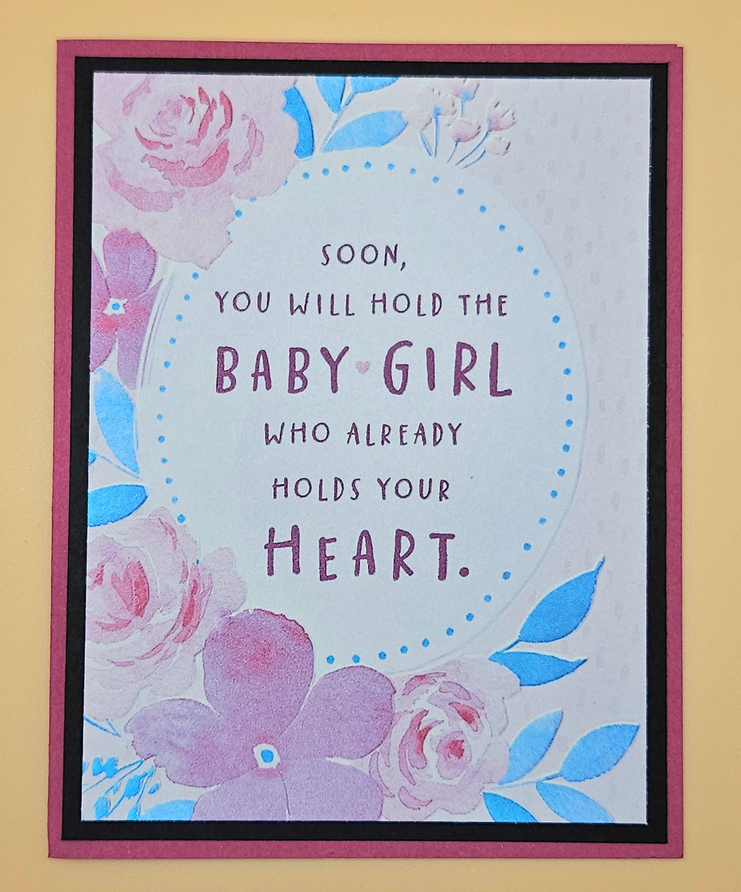 Framed card with floral design and text on a yellow background