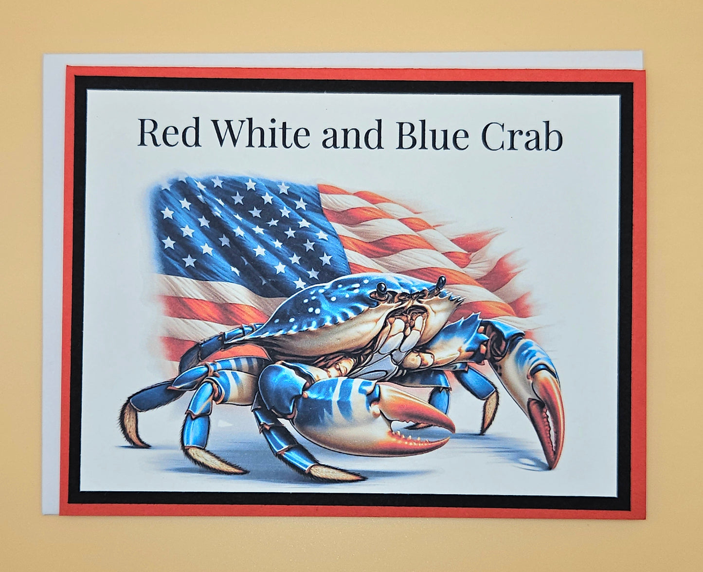 Card with a red, white, and blue crab design featuring an American flag on a beige background.