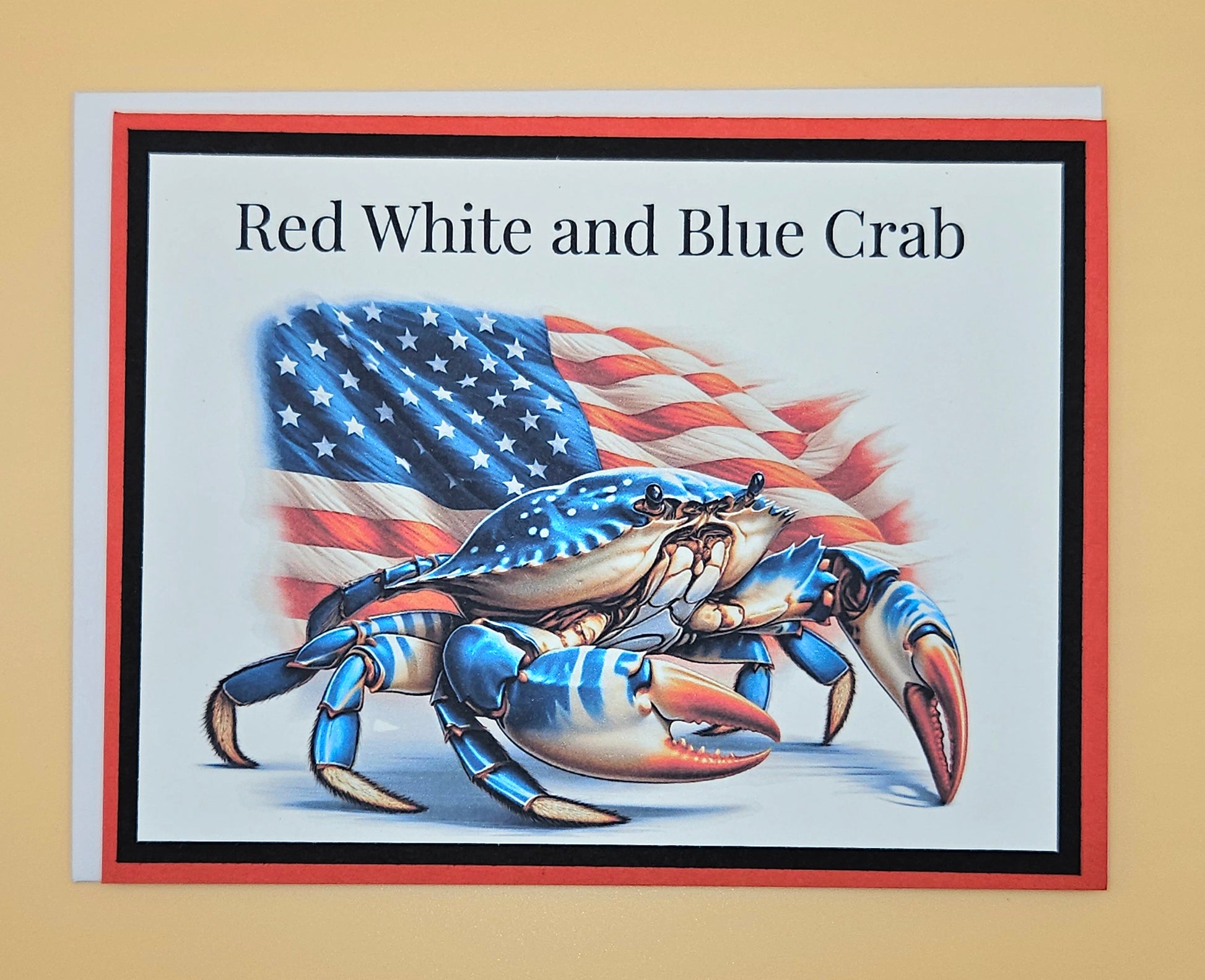 Card with a red, white, and blue crab design featuring an American flag on a beige background.