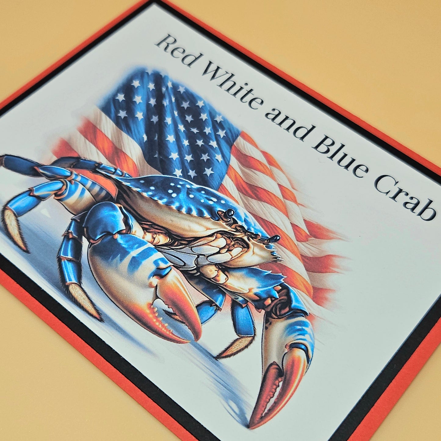 Decorative mat with a red, white, and blue crab design and American flag.