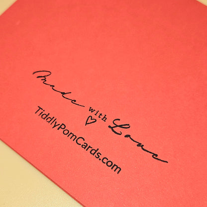 Red card with 'Made with Love' text and website URL on a beige background