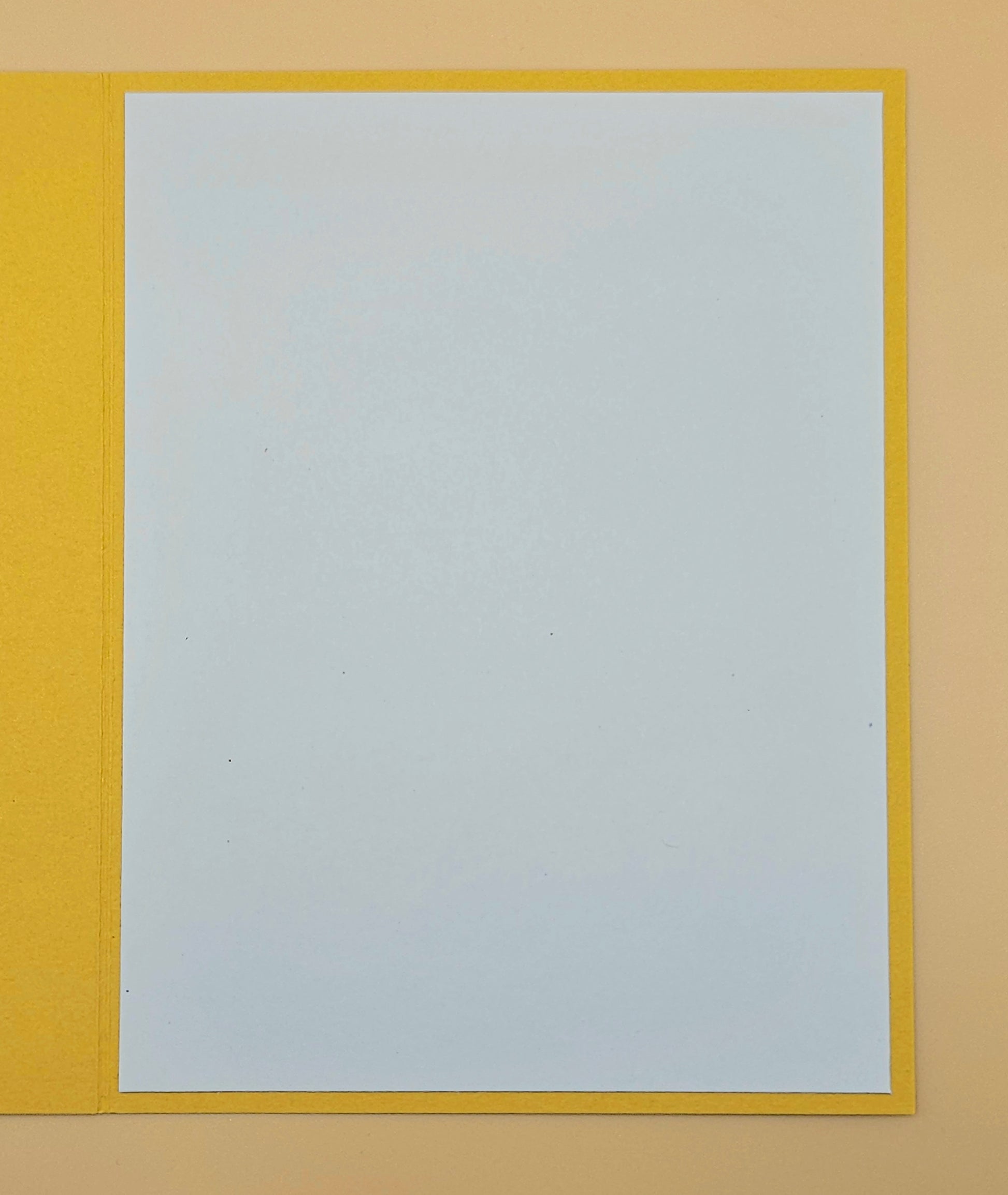 White sheet of paper on a yellow background