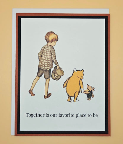 Handmade Winnie the Pooh friendship card featuring classic Christopher Robin Pooh and Piglet walking together illustration with warm rust-red and black layered cardstock frames